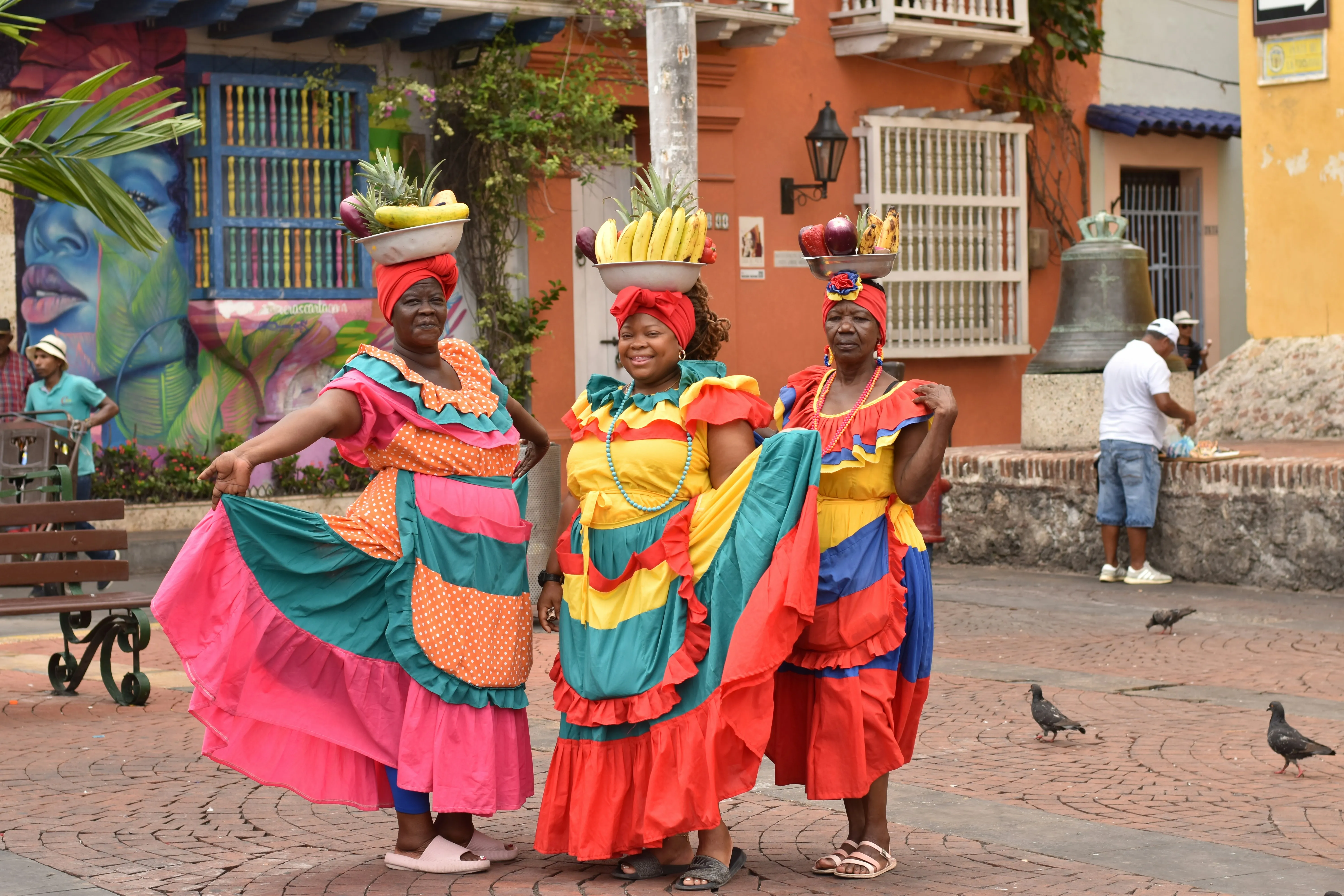 Palenqueras in traditional dress carrying fruit through the streets of Getsemaní