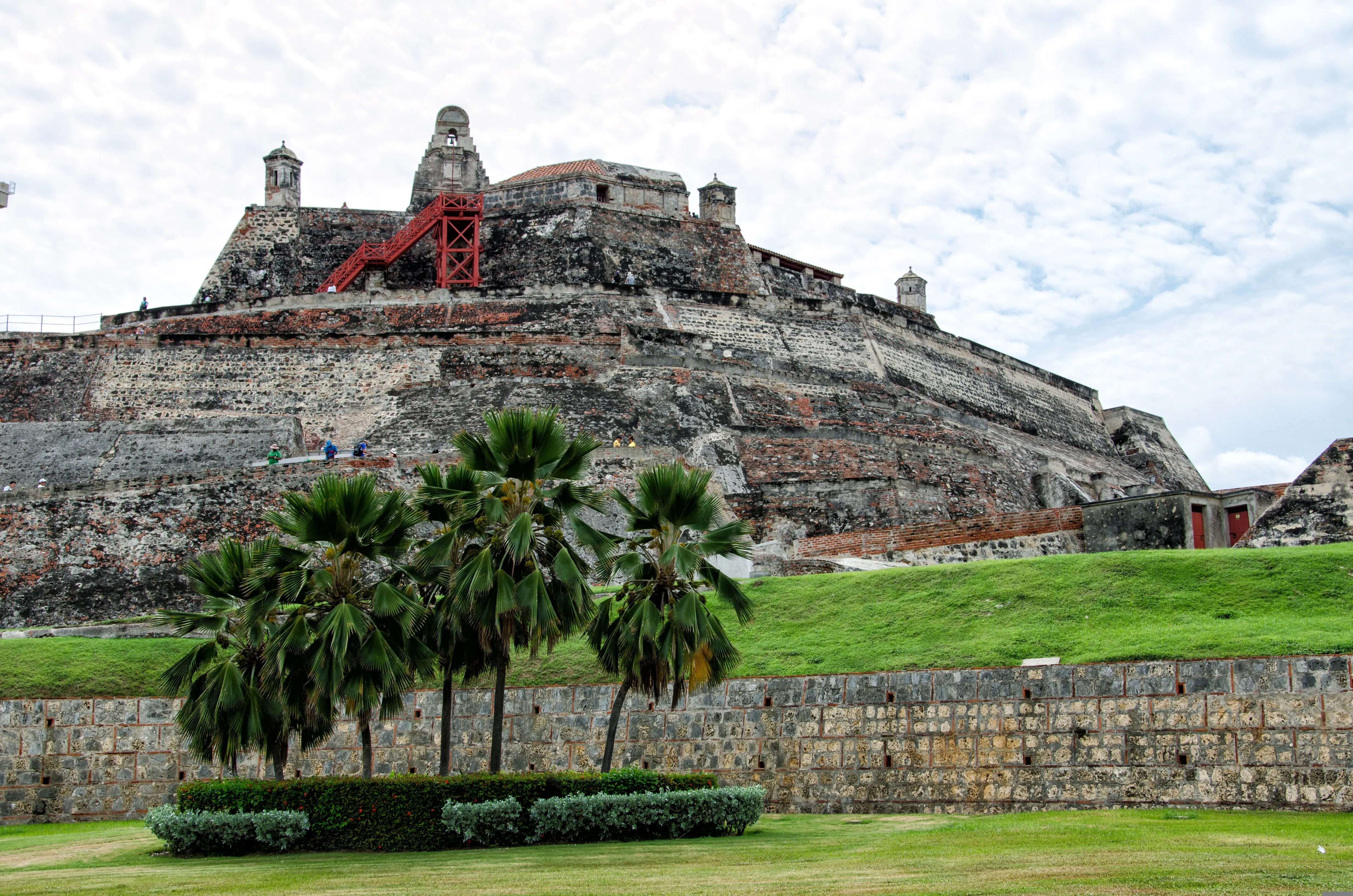 Castillo San Felipe de Barajas seen past a row of palm trees