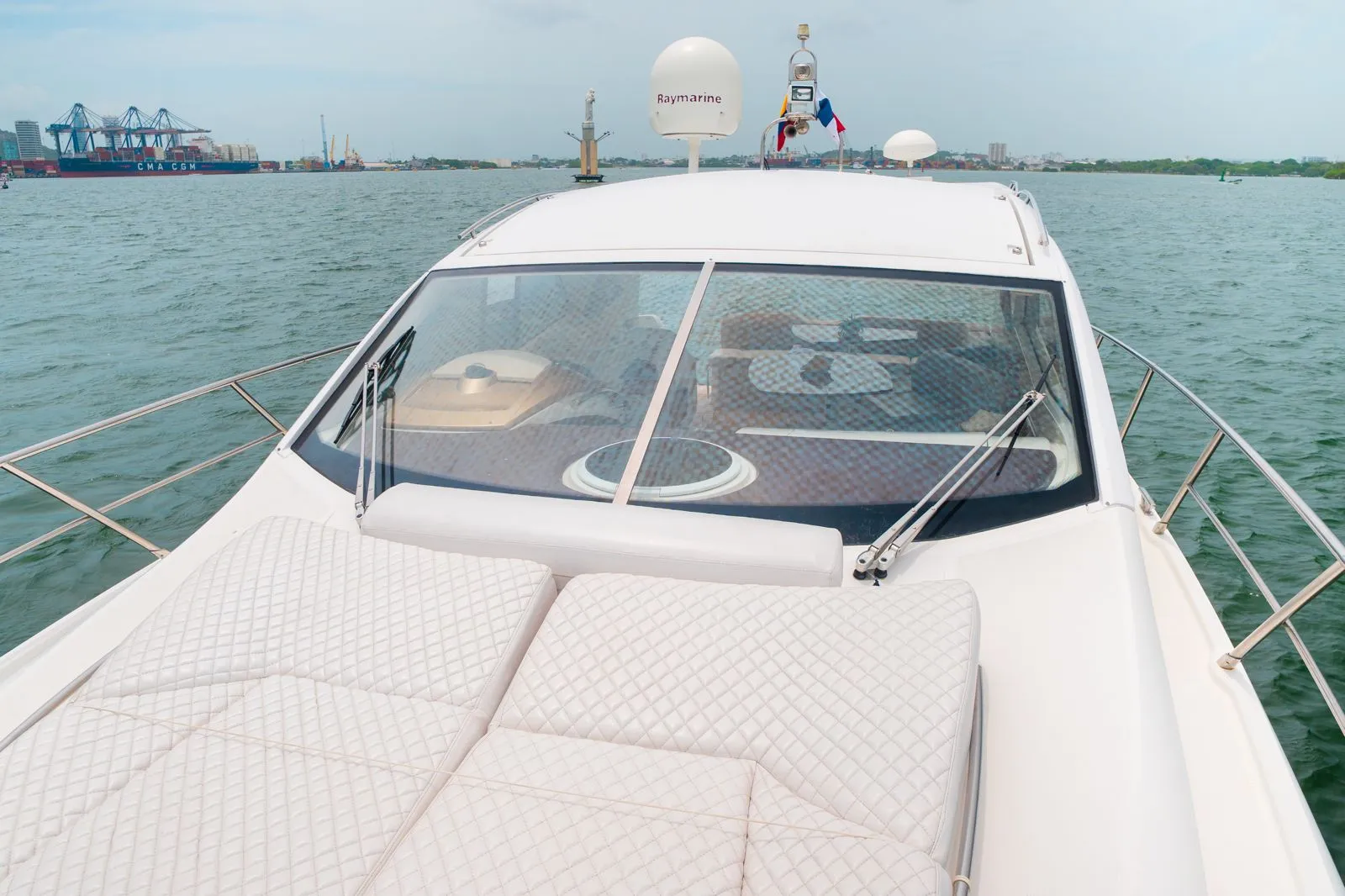 Forward bow seating aboard a private yacht, looking out over the water